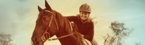 The Right Horse - Woman On Horseback With Helmet Smiling-header600 - Header 600